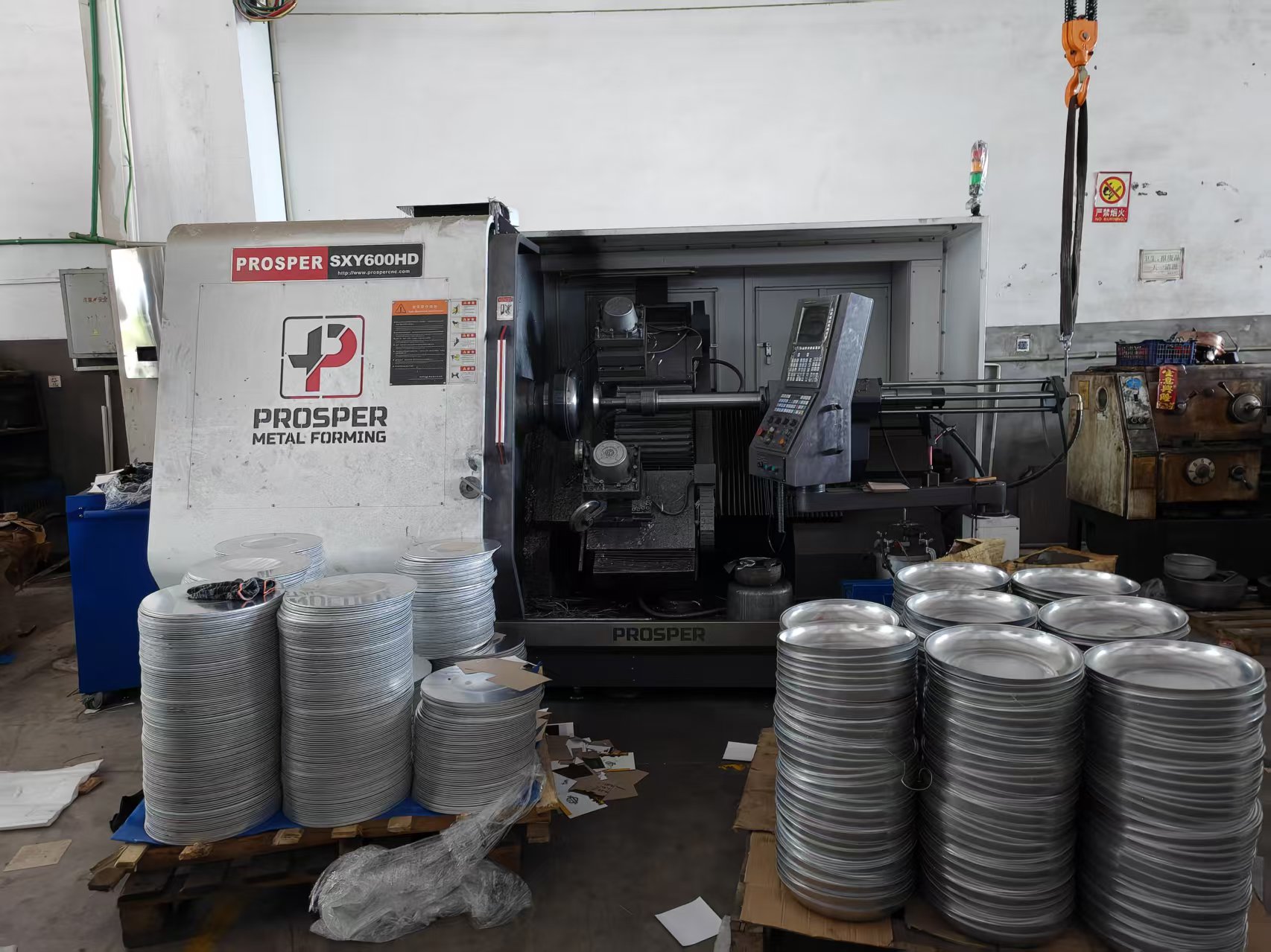 Metal forming equipment with stacks of cookware blanks